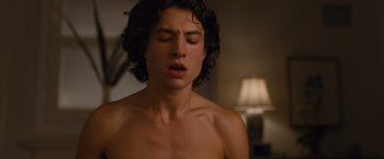 Movie still from “Trainwreck” (2015), directed by Judd Apatow – A young man with his eyes closed in a room; Close Up shot, Over the shoulder angle