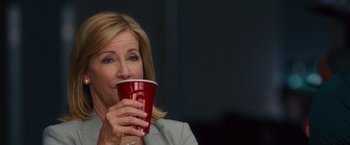 Movie still from “Trainwreck” (2015), directed by Judd Apatow – A woman is drinking a red cup of coffee; Close Up shot, Low angle