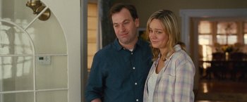 Movie still from “Trainwreck” (2015), directed by Judd Apatow – A man and a woman standing next to each other; Medium shot, Over the shoulder angle