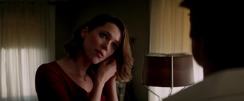 Movie still from “Transcendence” (2014), directed by Wally Pfister – A woman sitting in front of a lamp in a dark room; Close Up shot, Low angle