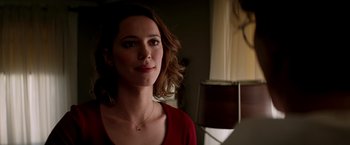 Movie still from “Transcendence” (2014), directed by Wally Pfister – A woman in a red shirt is standing in front of a microphone; Close Up shot, Over the shoulder angle