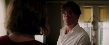 Movie still from “Transcendence” (2014), directed by Wally Pfister – A man wearing glasses talking to a woman in front of a window; Close Up shot, Over the shoulder angle