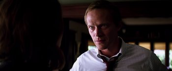 Movie still from “Transcendence” (2014), directed by Wally Pfister – A person wearing a shirt and a tie; Close Up shot, Over the shoulder angle