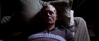 Movie still from “Transcendence” (2014), directed by Wally Pfister – A man is laying down with wires attached to his head; Close Up shot, Overhead angle