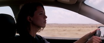 Movie still from “Transcendence” (2014), directed by Wally Pfister – A woman sitting in the driver's seat of a car looking out the window; Close Up shot, Over the shoulder angle