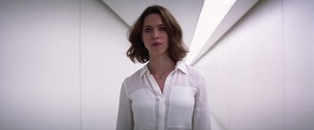 Movie still from “Transcendence” (2014), directed by Wally Pfister – A woman in a white shirt is looking at the camera; Close Up shot, Low angle