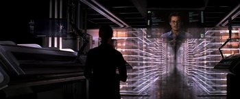 Movie still from “Transcendence” (2014), directed by Wally Pfister – A man standing next to a wall of glass; Wide shot, Over the shoulder angle