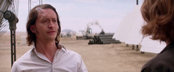 Movie still from “Transcendence” (2014), directed by Wally Pfister – A man standing in the middle of an empty field; Close Up shot, Over the shoulder angle