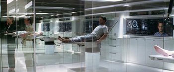 Movie still from “Transcendence” (2014), directed by Wally Pfister – A man sitting on a chair in a room; Wide shot, High angle