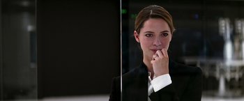 Movie still from “Transcendence” (2014), directed by Wally Pfister – A beautiful young woman in a black suit; Close Up shot, Over the shoulder angle