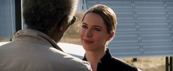 Movie still from “Transcendence” (2014), directed by Wally Pfister – A woman smiles at the camera while a man looks at her face; Close Up shot, Over the shoulder angle