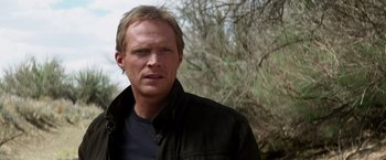 Movie still from “Transcendence” (2014), directed by Wally Pfister – A person wearing a black jacket; Close Up shot, Over the shoulder angle