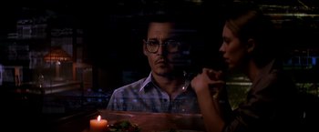 Movie still from “Transcendence” (2014), directed by Wally Pfister – A man and a woman sitting in front of a table; Close Up shot, Over the shoulder angle