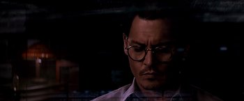 Movie still from “Transcendence” (2014), directed by Wally Pfister – A person wearing glasses; Close Up shot, Low angle