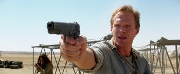 Movie still from “Transcendence” (2014), directed by Wally Pfister – A man holding a gun in his hand; Close Up shot, Low angle