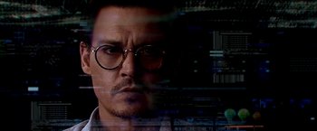 Movie still from “Transcendence” (2014), directed by Wally Pfister – A person wearing glasses and looking at the camera; Close Up shot, Low angle