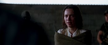 Movie still from “Transcendence” (2014), directed by Wally Pfister – A woman wrapped in a blanket looking at the camera; Close Up shot, Over the shoulder angle