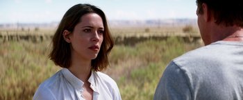 Movie still from “Transcendence” (2014), directed by Wally Pfister – A woman standing next to a man in a field; Close Up shot, Over the shoulder angle