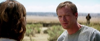 Movie still from “Transcendence” (2014), directed by Wally Pfister – A person wearing a gray t - shirt; Close Up shot, Over the shoulder angle