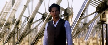 Movie still from “Transcendence” (2014), directed by Wally Pfister – A man standing in front of a metal structure; Medium shot, Low angle