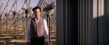 Movie still from “Transcendence” (2014), directed by Wally Pfister – A man standing next to a large telescope; Medium shot, Low angle