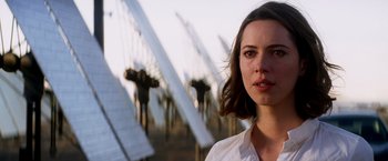 Movie still from “Transcendence” (2014), directed by Wally Pfister – A woman standing in front of a row of solar panels; Close Up shot, Over the shoulder angle