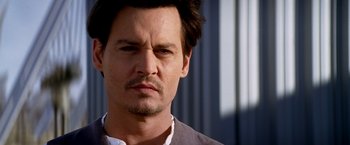 Movie still from “Transcendence” (2014), directed by Wally Pfister – A person wearing a shirt and tie; Close Up shot, Low angle