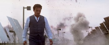 Movie still from “Transcendence” (2014), directed by Wally Pfister – A man in a suit walking in front of smoke; Medium shot, Low angle