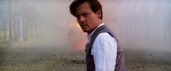Movie still from “Transcendence” (2014), directed by Wally Pfister – A man in a white dress shirt and a gray vest; Close Up shot, Low angle