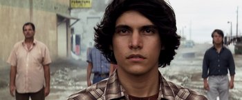 Movie still from “Transcendence” (2014), directed by Wally Pfister – A man with long hair and a plaid shirt; Close Up shot, Low angle