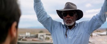 Movie still from “Transcendence” (2014), directed by Wally Pfister – An older man wearing a cowboy hat and sunglasses; Close Up shot, Low angle