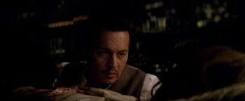 Movie still from “Transcendence” (2014), directed by Wally Pfister – A person sitting in front of a plate of food; Close Up shot, High angle