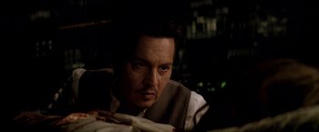 Movie still from “Transcendence” (2014), directed by Wally Pfister – A person with a knife in his hand; Close Up shot, Over the shoulder angle