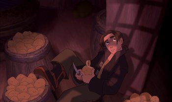 Movie still from “Treasure Planet” (2002), directed by John Musker – A man sitting on the ground holding a knife; Medium shot, Overhead angle