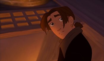 Movie still from “Treasure Planet” (2002), directed by John Musker – A man with long brown hair is looking at the camera; Close Up shot, Low angle