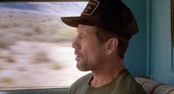 Movie still from “Tremors” (1990), directed by Ron Underwood – A person wearing a hat; Close Up shot, Low angle