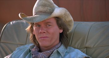 Movie still from “Tremors” (1990), directed by Ron Underwood – A person wearing a cowboy hat; Close Up shot, Low angle