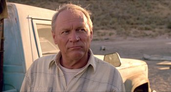 Movie still from “Tremors” (1990), directed by Ron Underwood – An older man standing in front of a truck; Close Up shot, Low angle