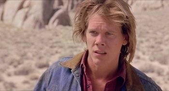 Movie still from “Tremors” (1990), directed by Ron Underwood – A person with long hair; Close Up shot, Low angle