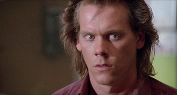 Movie still from “Tremors” (1990), directed by Ron Underwood – A person with long hair; Close Up shot, Low angle