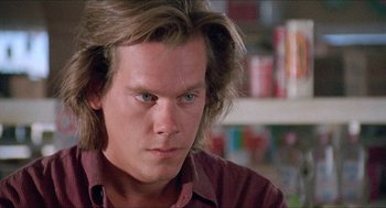 Movie still from “Tremors” (1990), directed by Ron Underwood – A person with long brown hair; Close Up shot, Low angle