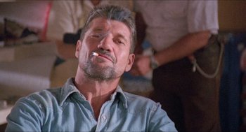 Movie still from “Tremors” (1990), directed by Ron Underwood – A person smoking a cigarette; Close Up shot, Low angle