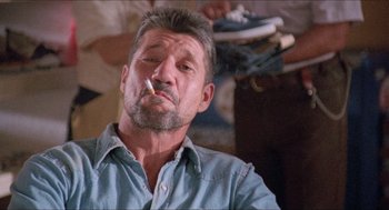 Movie still from “Tremors” (1990), directed by Ron Underwood – A person with a cigarette in his mouth; Close Up shot, Low angle