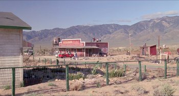 Movie still from “Tremors” (1990), directed by Ron Underwood – An old red building in the middle of the desert; Extreme Wide shot, Low angle