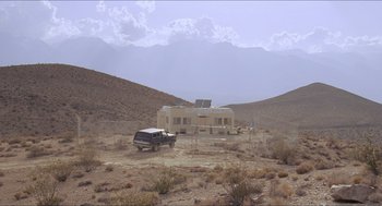 Movie still from “Tremors” (1990), directed by Ron Underwood – A truck parked in the middle of the desert; Extreme Wide shot, Low angle