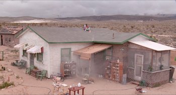 Movie still from “Tremors” (1990), directed by Ron Underwood – An old house in the middle of a desert; Extreme Wide shot, High angle