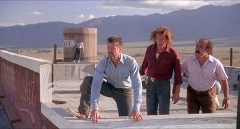 Movie still from “Tremors” (1990), directed by Ron Underwood – A man and a woman climbing a ramp; Wide shot, Low angle