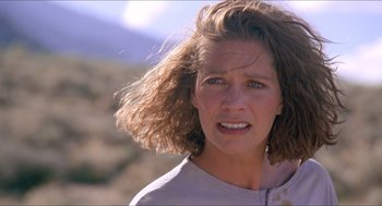 Movie still from “Tremors” (1990), directed by Ron Underwood – A person with long brown hair; Close Up shot, Low angle