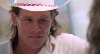 Movie still from “Tremors” (1990), directed by Ron Underwood – A person wearing a hat; Close Up shot, Over the shoulder angle