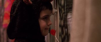 Movie still from “Trick 'r Treat” (2007), directed by Michael Dougherty – A young girl holding a lollipop in her mouth; Close Up shot, Over the shoulder angle